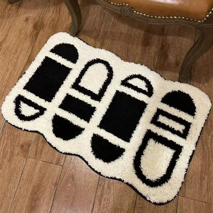 Tufted black and white geometric area rug with a soft, plush texture and anti-slip backing