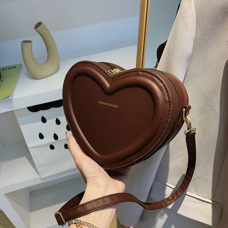 Chic heart-shaped crossbody bag made from premium PU leather, available in multiple stylish colours