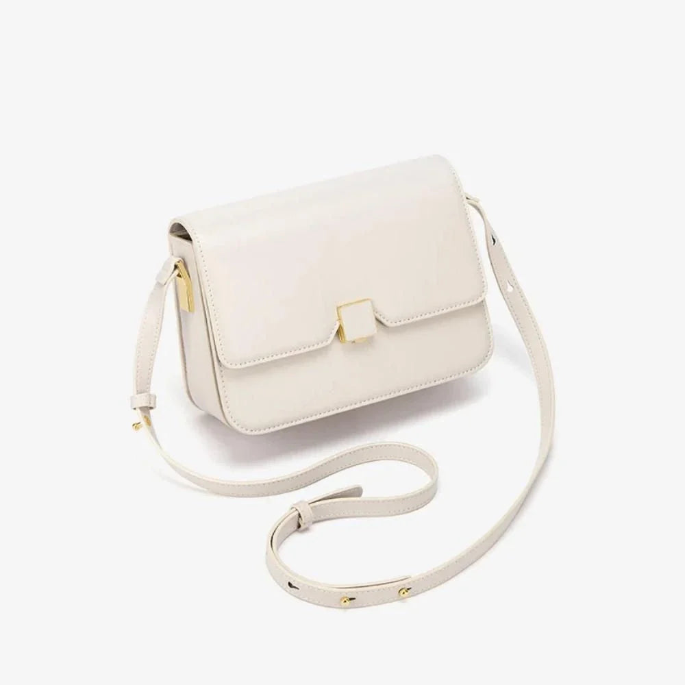 Stylish British-inspired leather shoulder and crossbody bag in black, tan, and navy colours