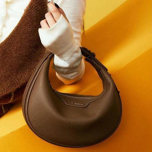 Stylish crescent-shaped leather crossbody bag with soft, supple texture for everyday elegance