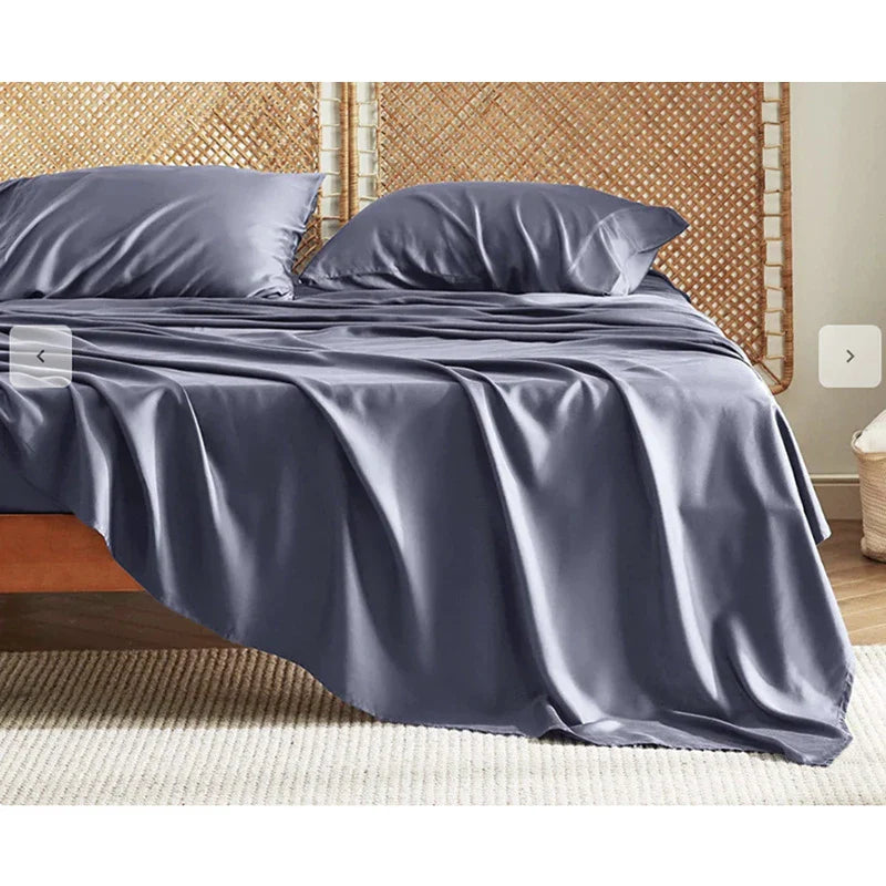 Premium bamboo fibre bed sheets in a classic solid purplish blue colour, featuring a four-piece set including a fitted sheet, flat sheet, and two pillowcases.