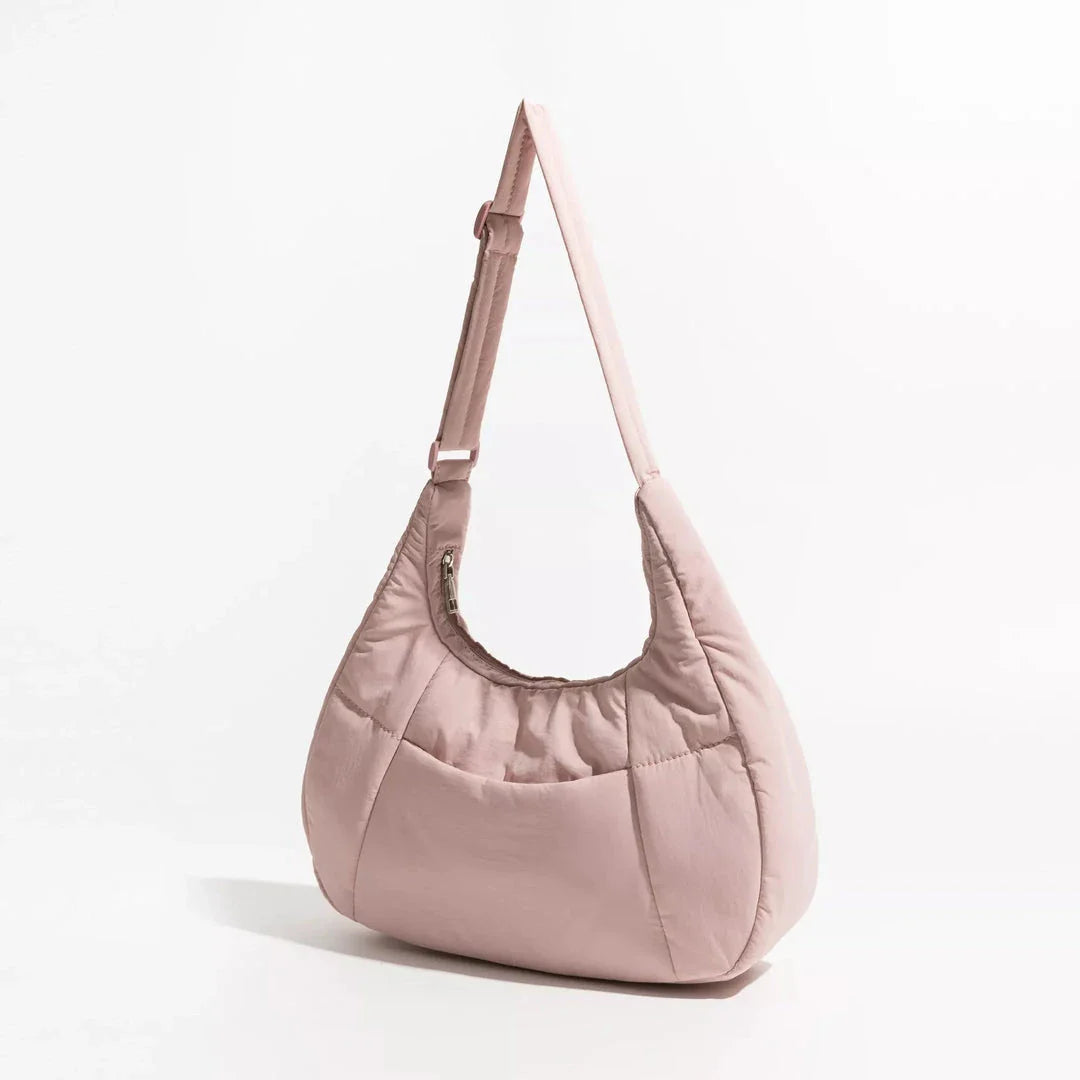 Chic Half Moon Puffer Shoulder Bag in a stylish pink colour, featuring a unique design and practical features for the modern woman.