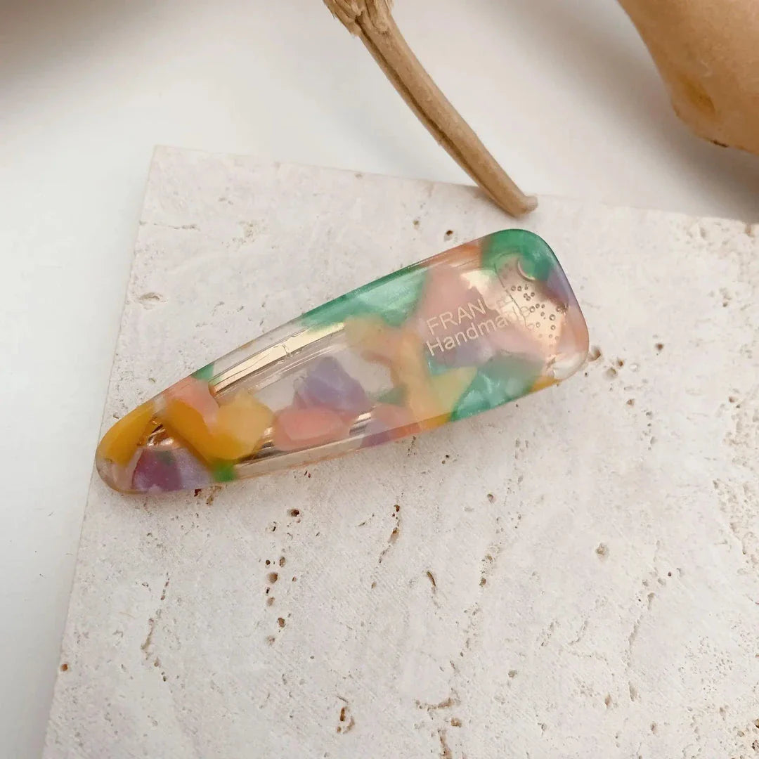 Two marble-patterned hair clips in a contemporary geometric design, made from high-quality acetate and acrylic materials.