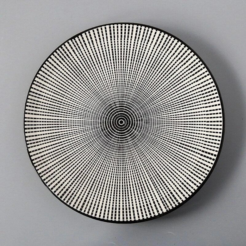 Elegant ceramic plates with vibrant, whimsical prints in a variety of enchanting designs