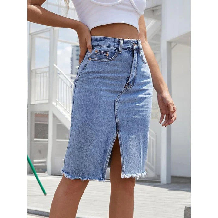 High-waist denim midi skirt with split hem and zipper closure, made from a comfortable cotton-polyester blend for a flattering, structured fit.