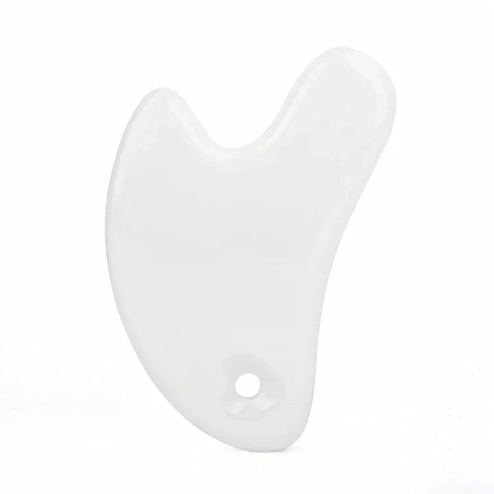 Ceramic Gua Sha facial massager in blue, pink, and white colours, designed to improve circulation and promote lymphatic drainage for radiant, youthful skin.