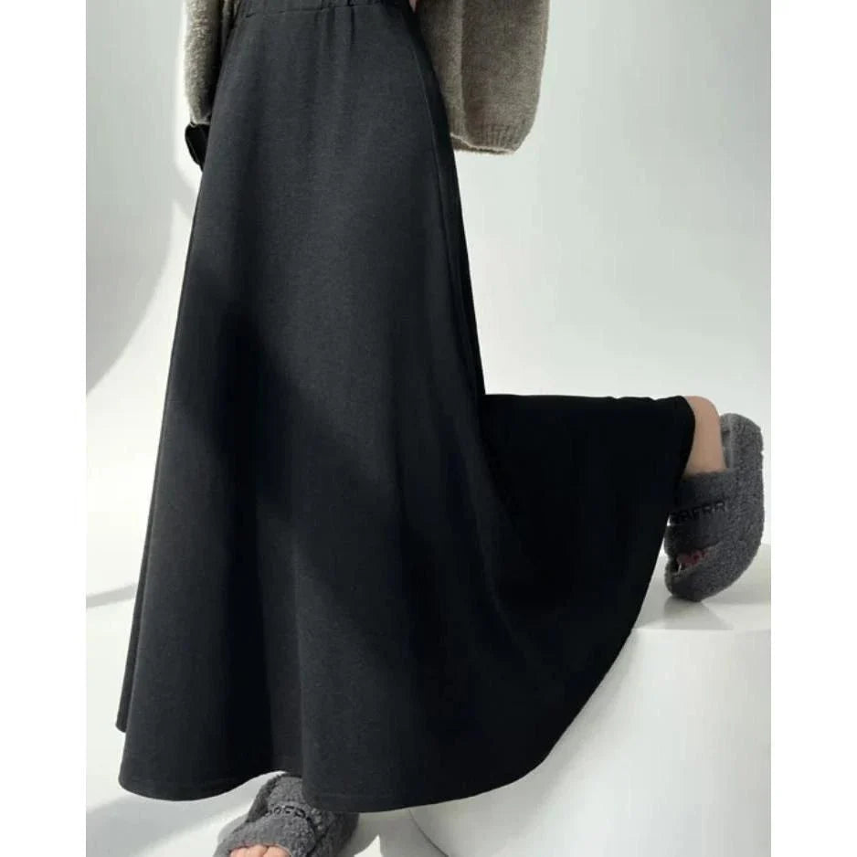 Elegant high-waist knitted skirt in black, showcasing a flattering A-line silhouette and ankle-length cut for the modern British woman.