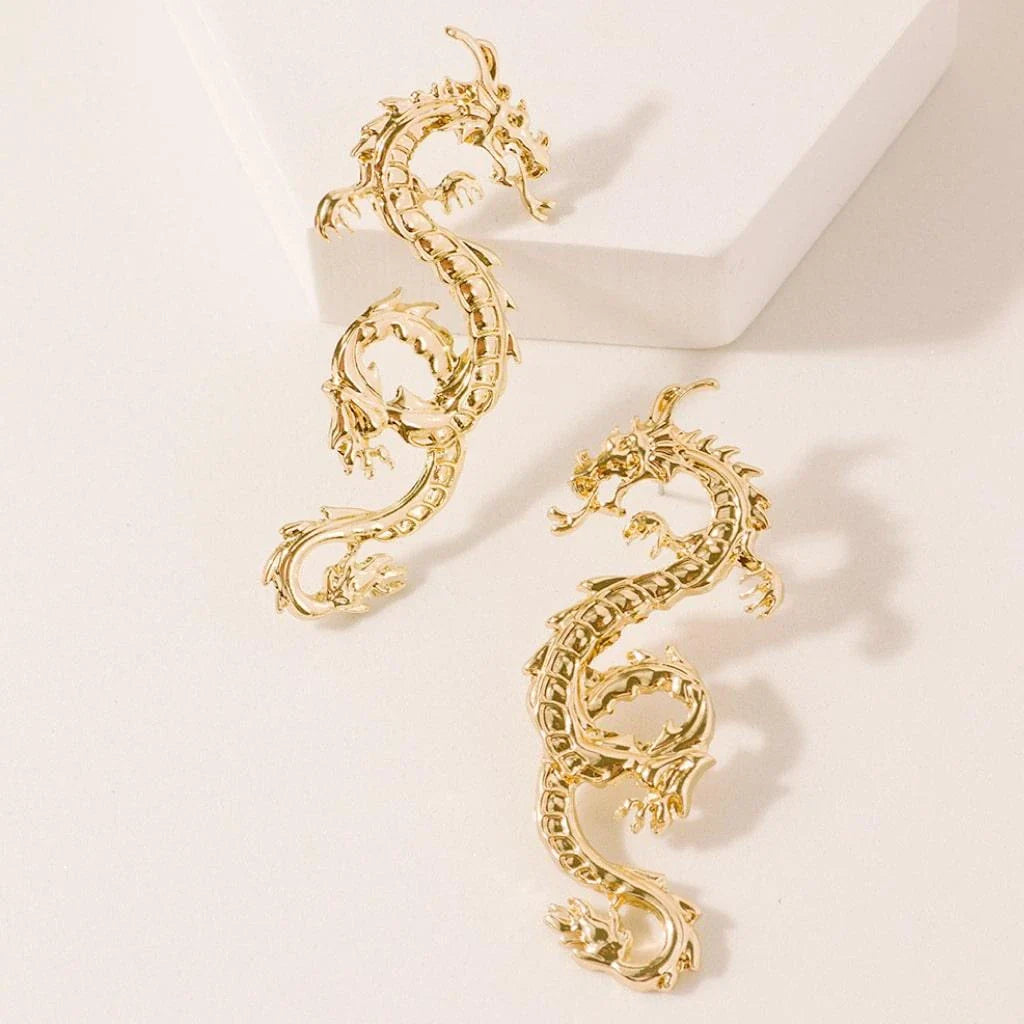 Stunning gold-coloured dragon stud earrings with intricate details, a fashionable accessory for UK customers