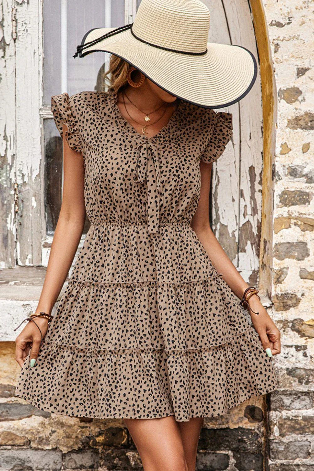 Elegant leopard-print tiered dress with butterfly sleeves, a stylish and versatile casual dress for any occasion.