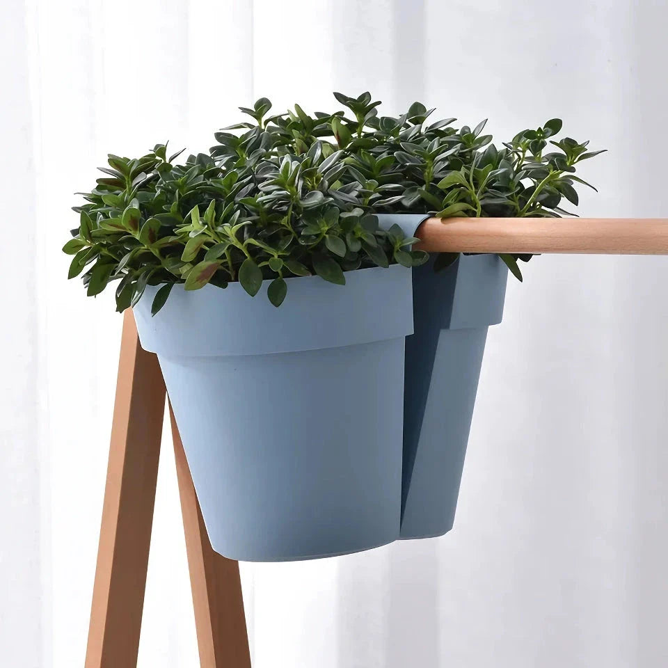 Stylish double-sided hanging rail planter in white, designed to display flowers and plants on both sides of a railing or surface