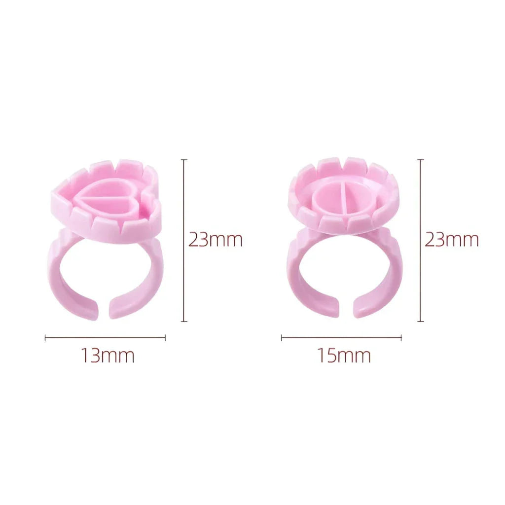 Heart-shaped disposable eyelash glue rings in blue, pink, and white colours