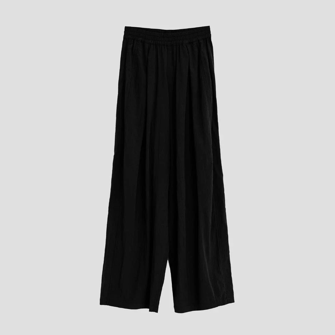 Pleated wide-leg high-waisted trousers in a herringbone plaid pattern, featuring a flattering silhouette and comfortable cotton-linen blend