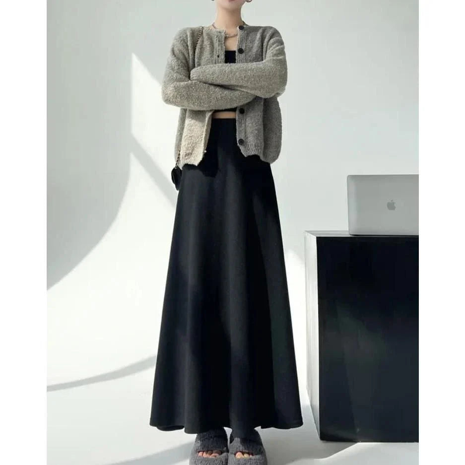 Elegant high-waist knitted skirt in black, showcasing a flattering A-line silhouette and ankle-length cut for the modern British woman.