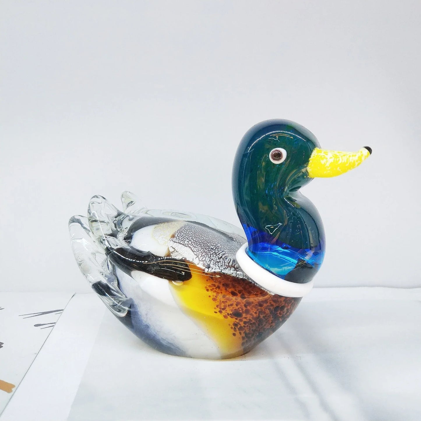 Handcrafted glass ornament in the shape of a Mandarin duck with vibrant colours and intricate details
