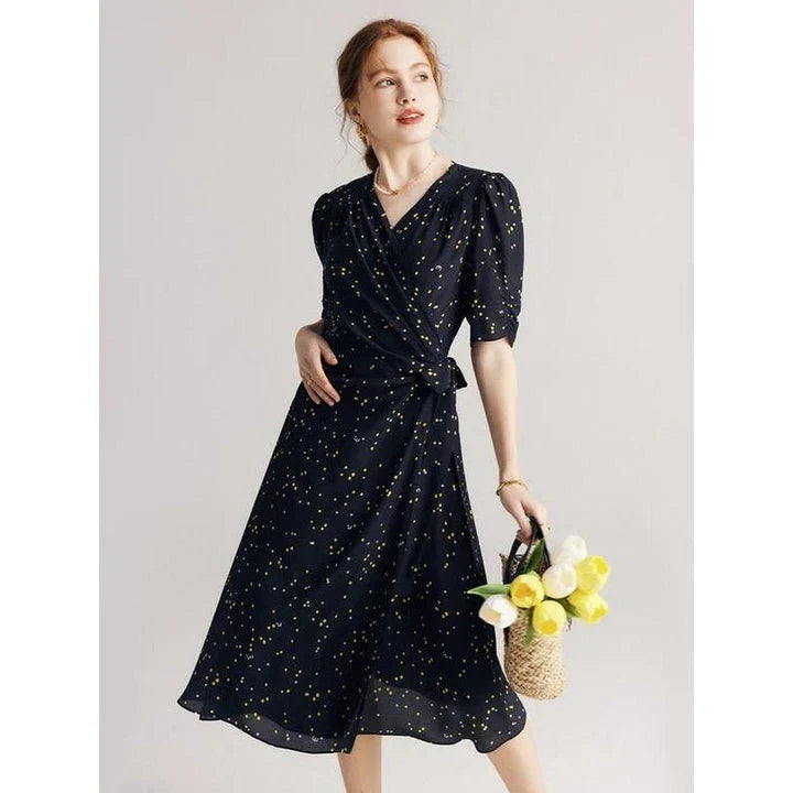 Sophisticated black polka dot silk wrap dress with a flattering V-neck and empire waistline, suitable for various occasions.