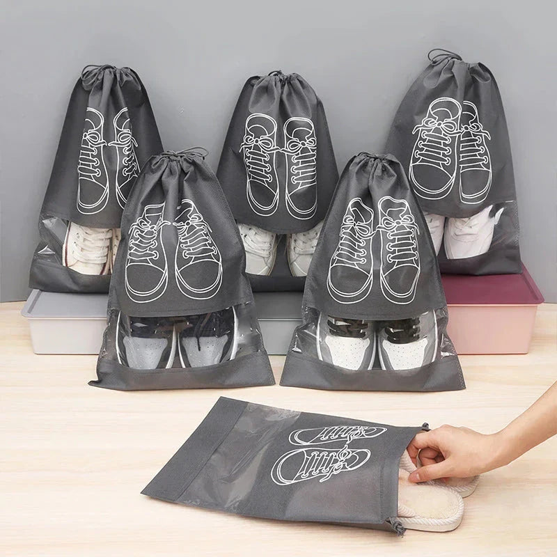 A set of grey travel shoe storage organiser bags with transparent panels for easy identification of contents