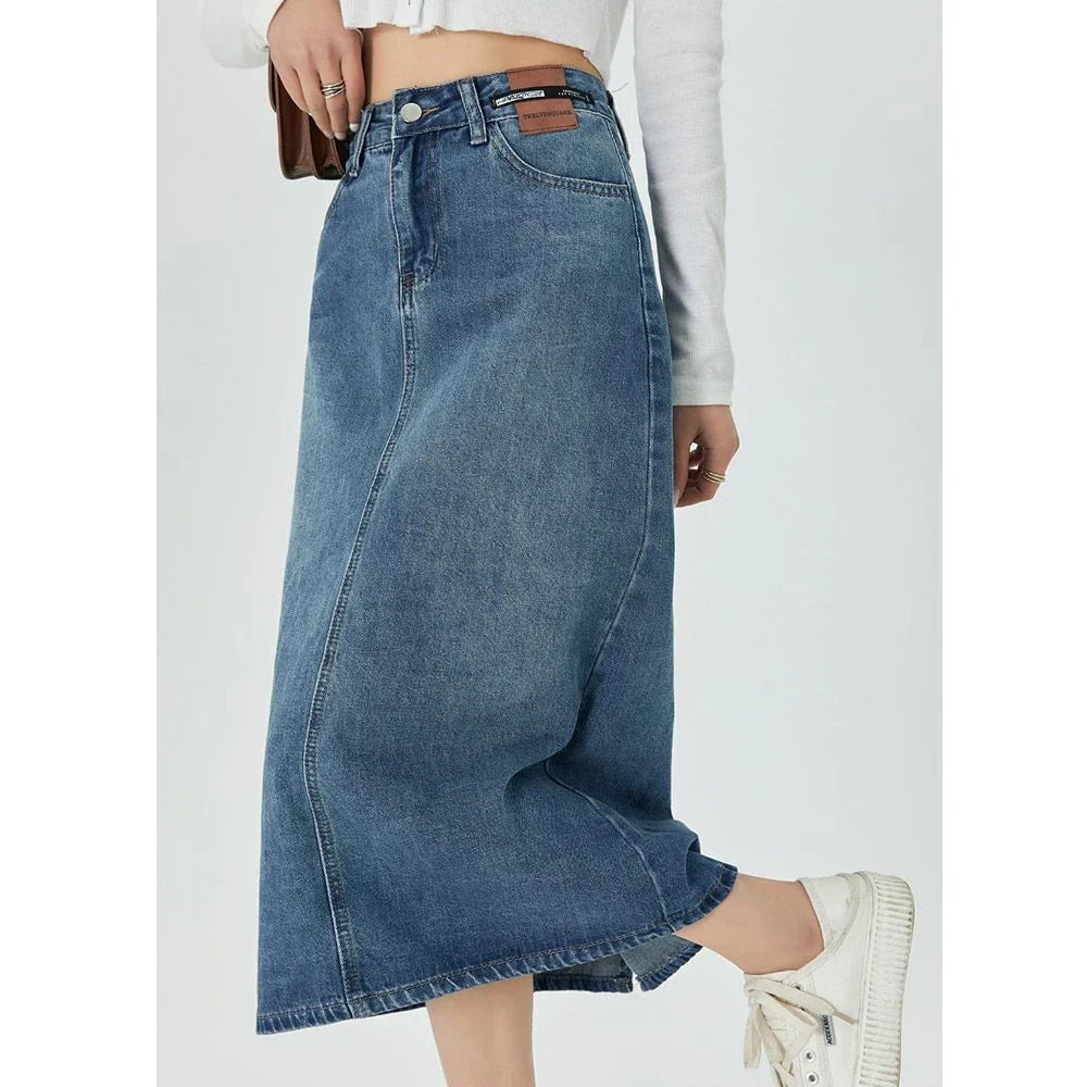 Classic blue A-line midi denim skirt with flattering empire waistline and flowy silhouette