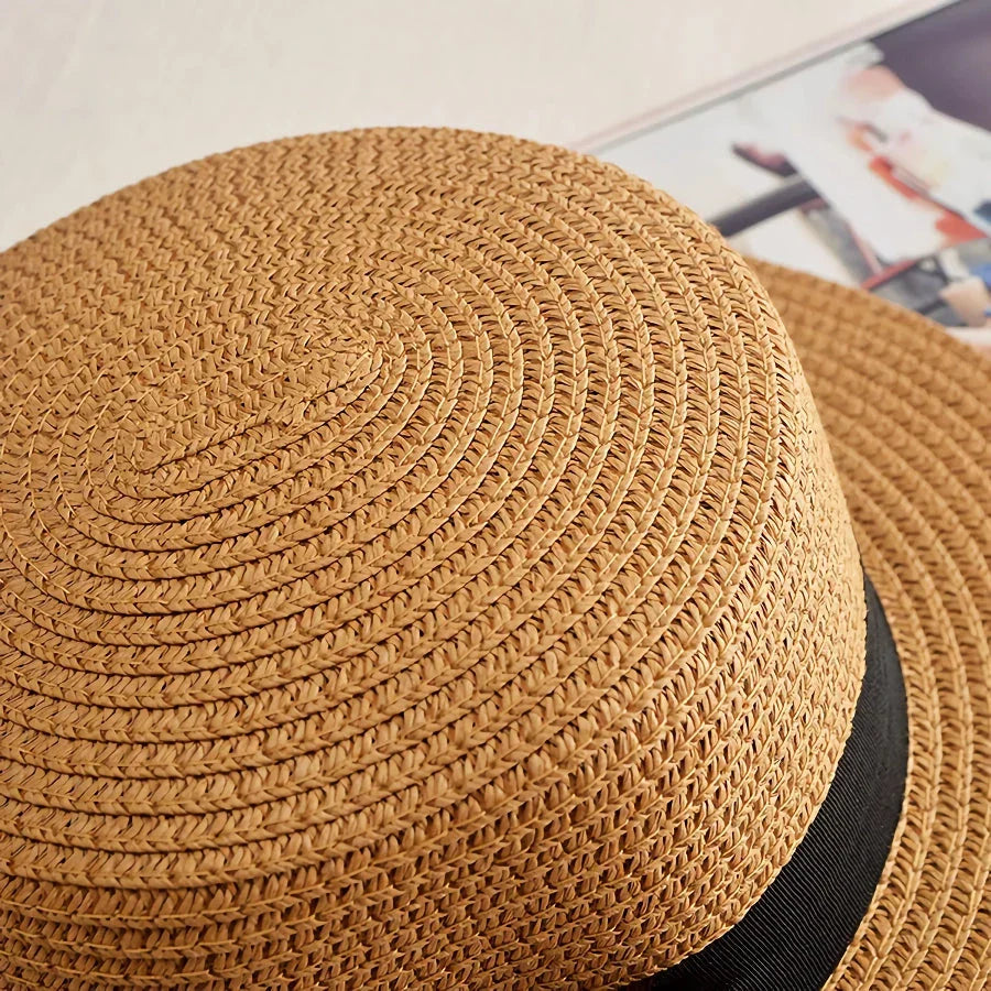 A classic summer Panama hat made from straw and paper, featuring a charming bow detail that adds a feminine touch.