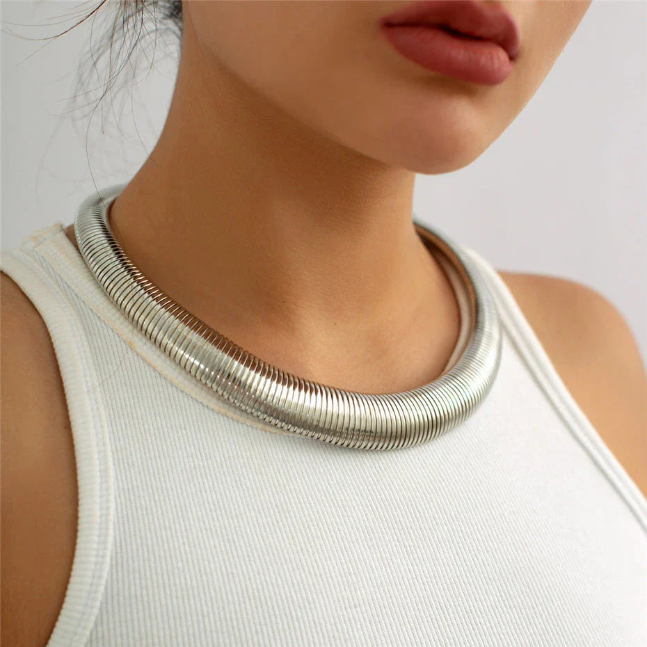 Captivating spiral chunky choker necklace in gold and silver colours, featuring a bold, geometric design for a unique, statement-making look.