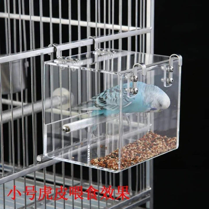A transparent acrylic bird feeder cube with a sleek and modern design, perfect for adding a touch of elegance to your garden or balcony.