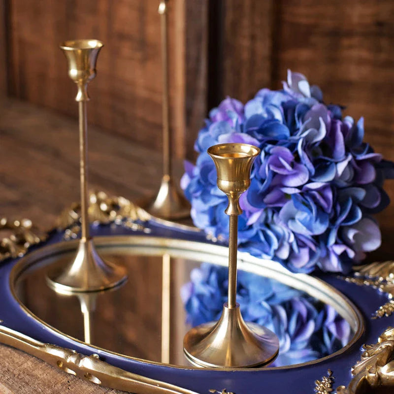Elegant brass gold candlestick holder set with varying heights, perfect for enhancing the ambiance of any room in the home.