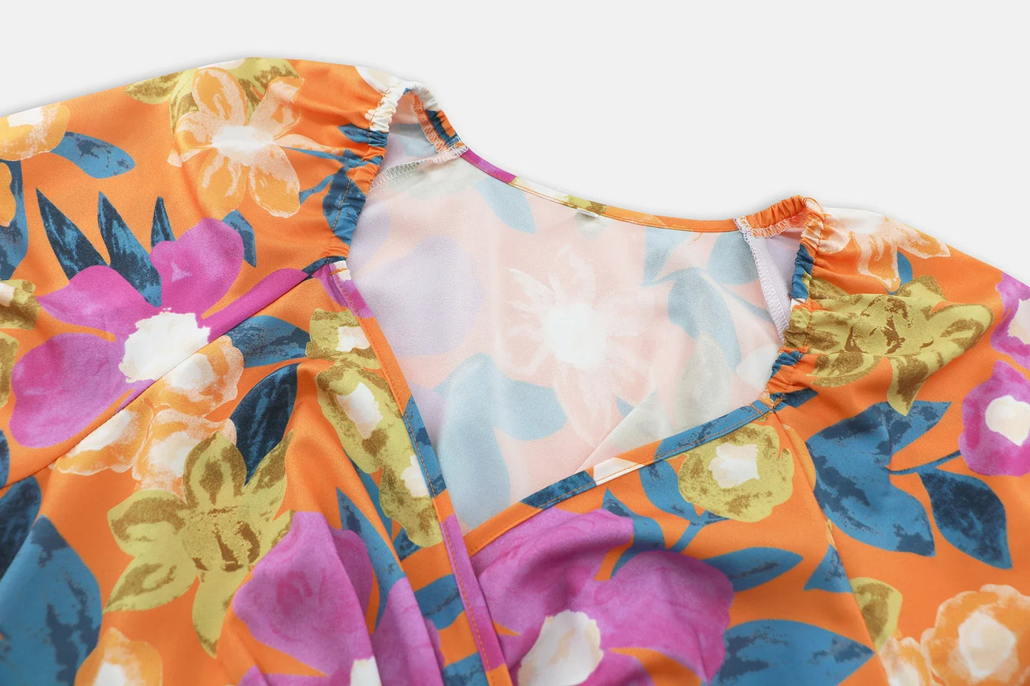 Stylish lantern-sleeve v-neck beach dress in vibrant summer colours, featuring a flattering fit and comfortable stretch fabric