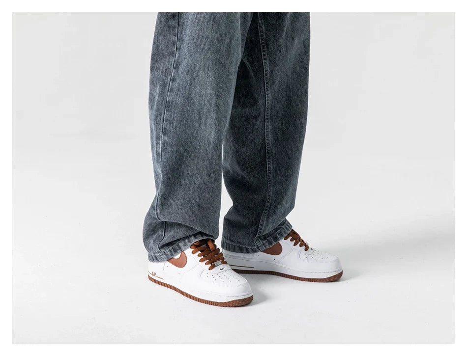 A pair of stylish retro-inspired Japanese jeans in black and grey, featuring a mid-rise waist and straight leg silhouette for a flattering, comfortable fit.