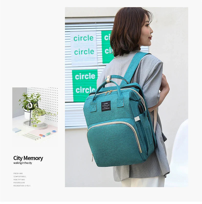 Multifunctional maternity diaper backpack with removable mosquito net, foldable crib, and water-resistant design for convenient family travel