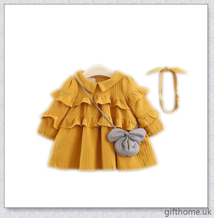 A beautiful summer dress for girls with a delicate floral pattern, long sleeves, and included accessories like a hair accessory and handbag