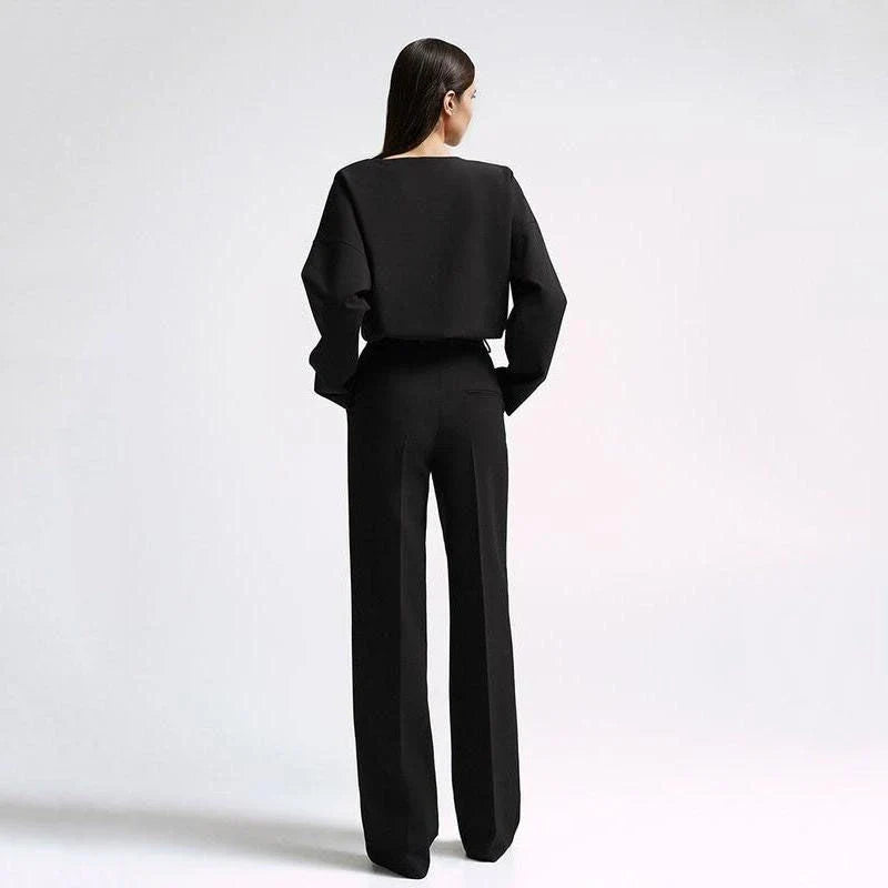 Elegant and sophisticated women's two-piece office suit with long sleeve top and wide-leg pants in a neutral colour palette