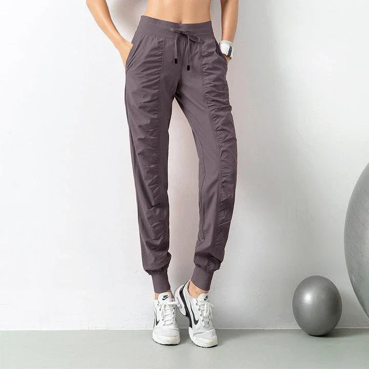 Premium women's sports trousers with drawstring waist and pockets, made of high-quality nylon fabric for comfort and versatility.