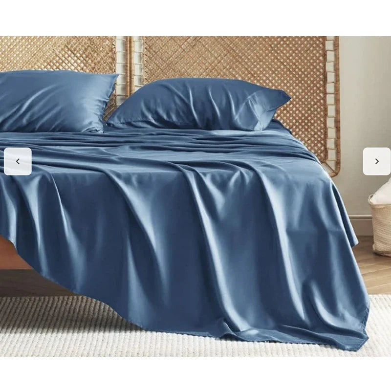 Premium bamboo fibre bed sheets in a classic solid purplish blue colour, featuring a four-piece set including a fitted sheet, flat sheet, and two pillowcases.