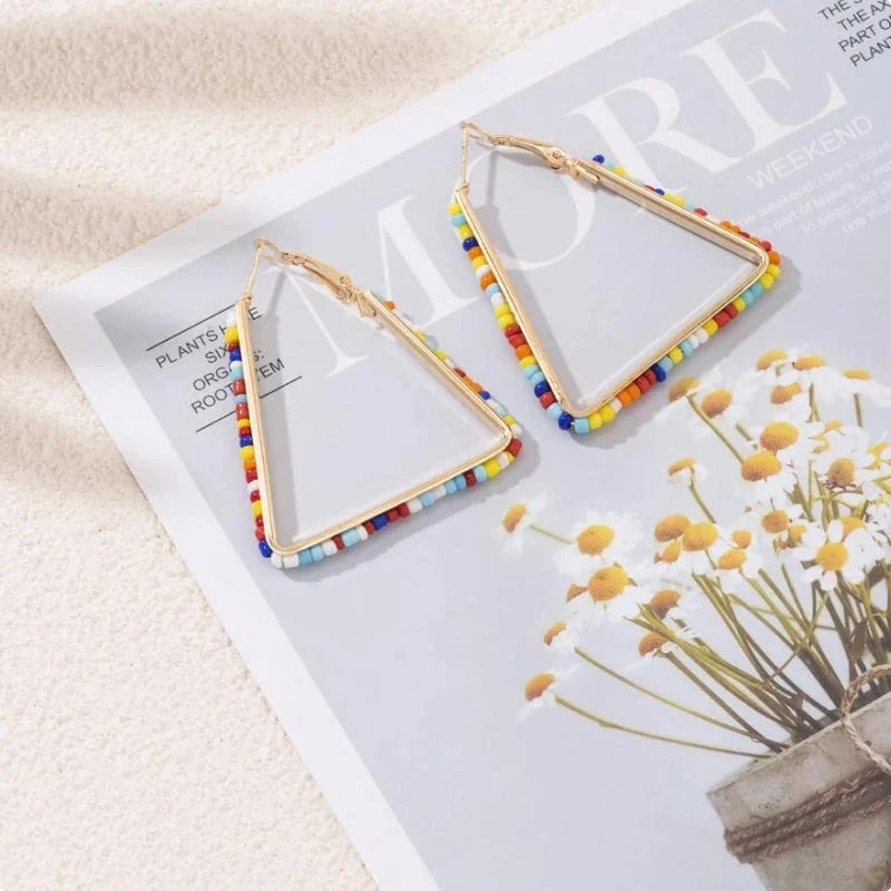 Colourful beaded triangle hoop earrings in gold metal with vibrant beadwork