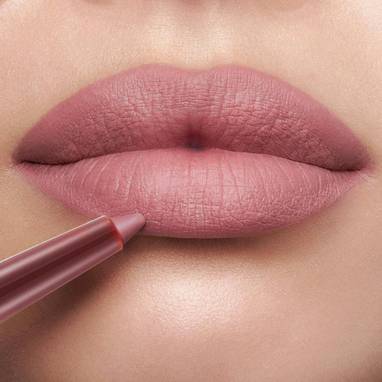 Close-up of a premium waterproof lipliner in a silver casing, a must-have makeup essential for a polished and long-lasting lip look.