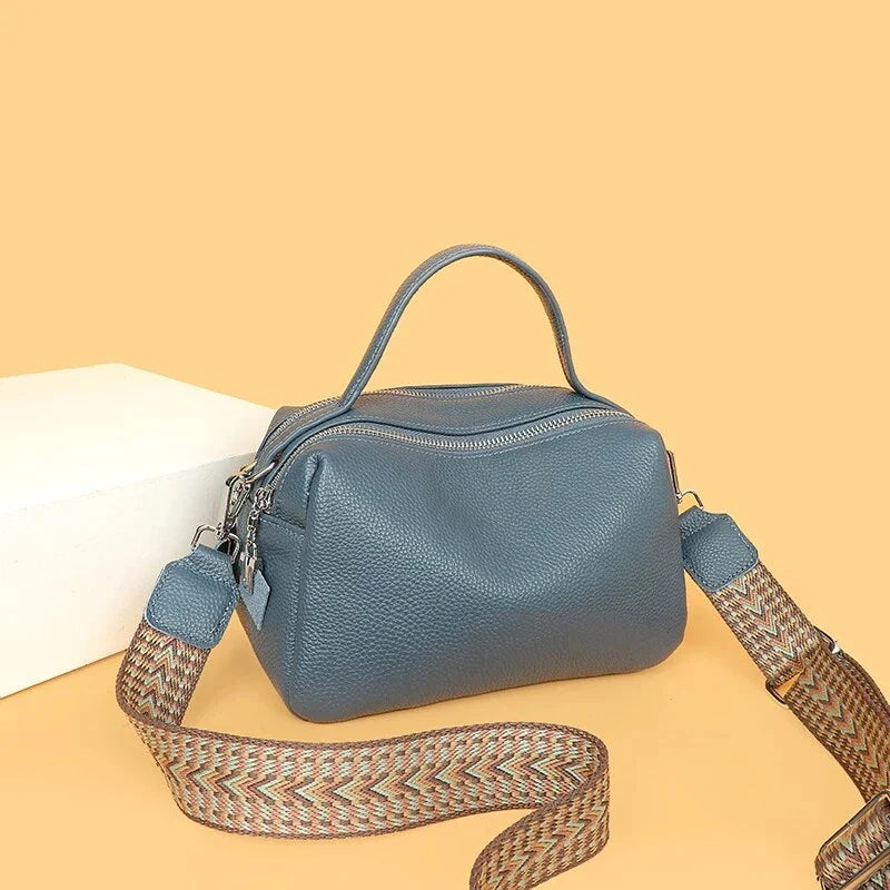 Luxurious genuine leather crossbody bag for women, featuring a soft polyester lining, dual phone pockets, and a compact, square design.