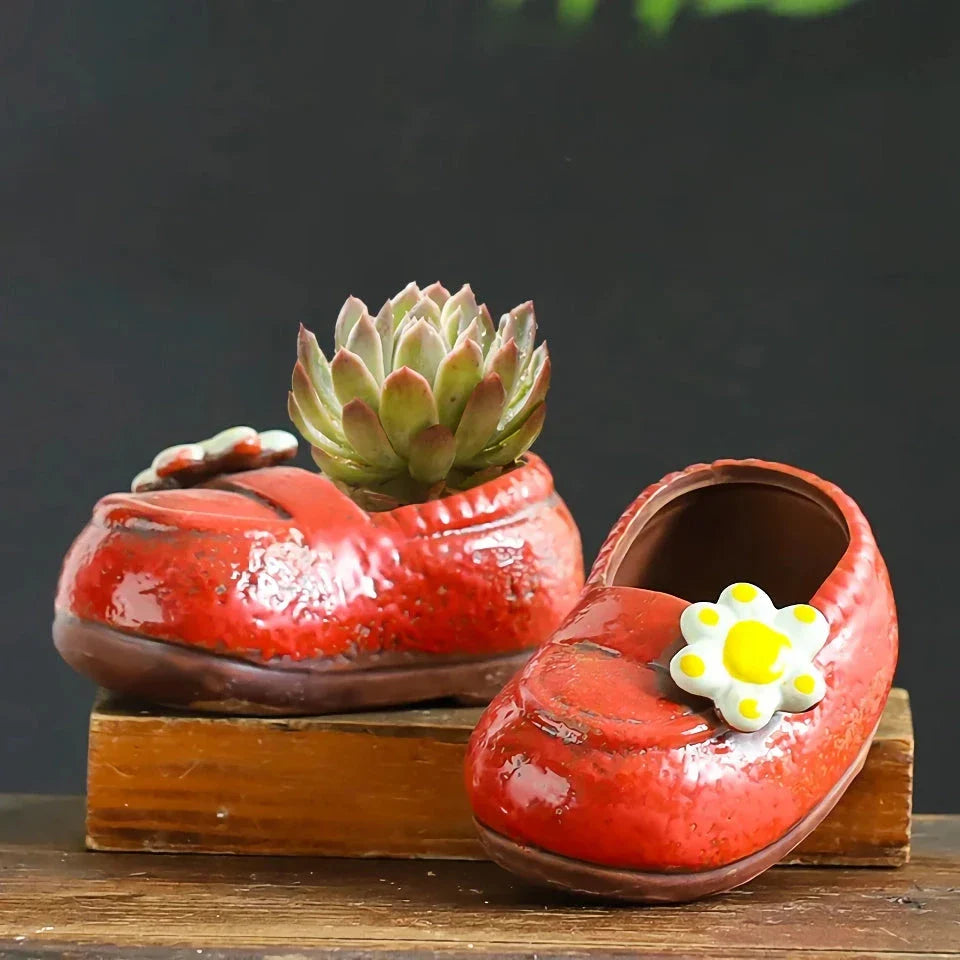 Charming ceramic boot-shaped vase with a glazed finish, perfect for displaying succulents and flowers in your home or garden