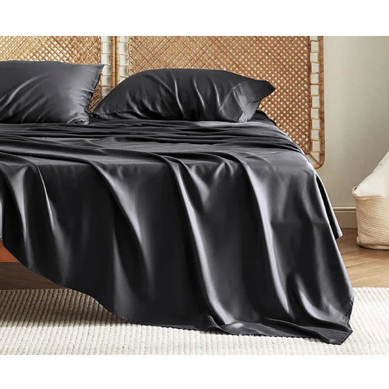 Premium bamboo fibre bed sheets in a classic solid purplish blue colour, featuring a four-piece set including a fitted sheet, flat sheet, and two pillowcases.