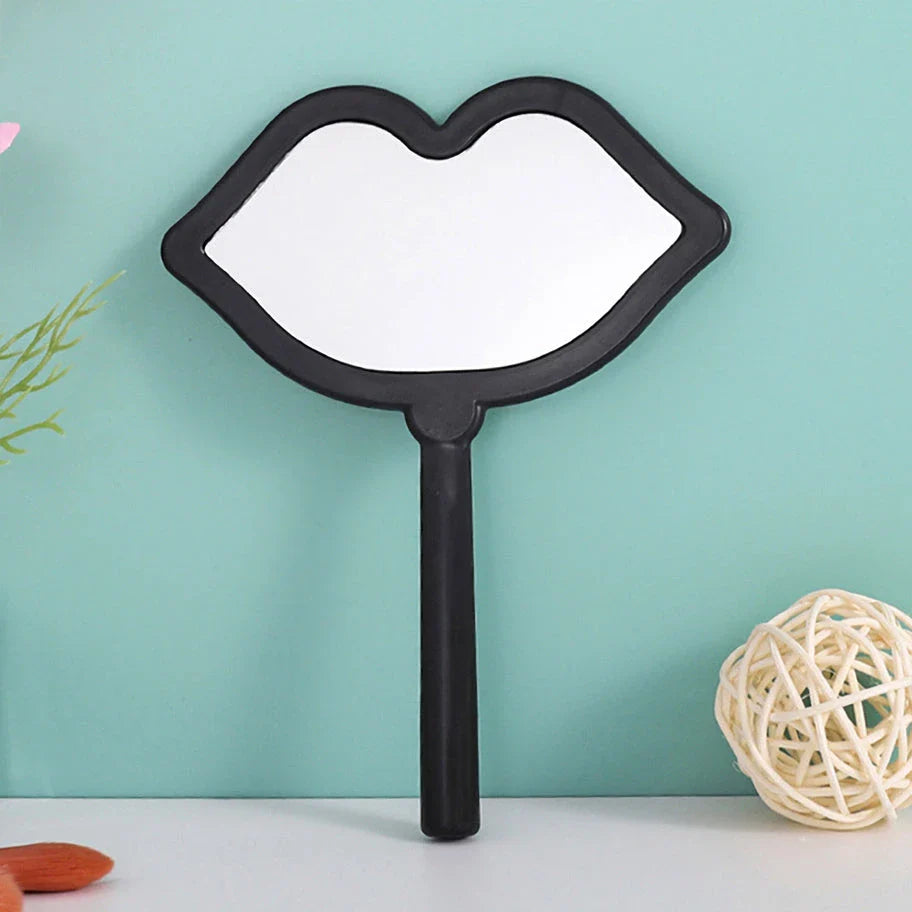 Lip-shaped handheld makeup mirror with a comfortable ergonomic handle for precise on-the-go touch-ups