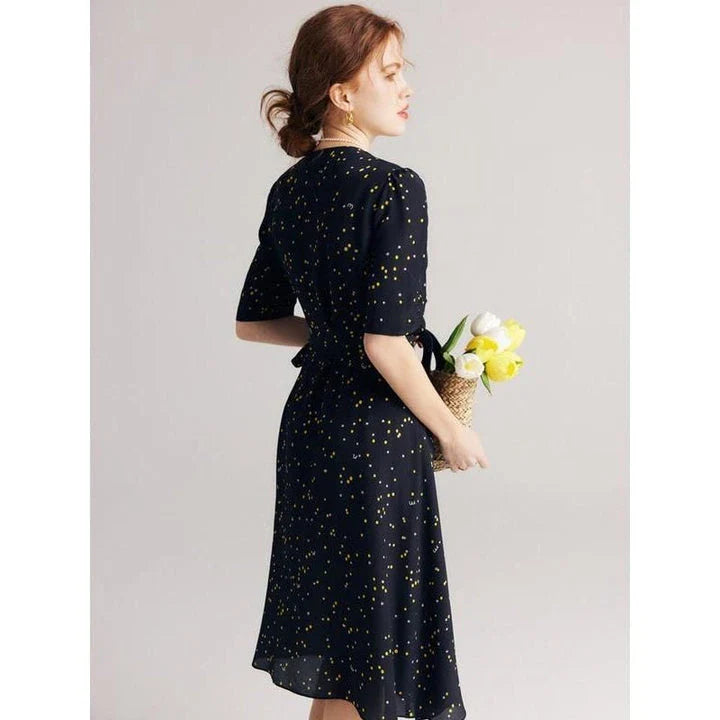 Sophisticated black polka dot silk wrap dress with a flattering V-neck and empire waistline, suitable for various occasions.
