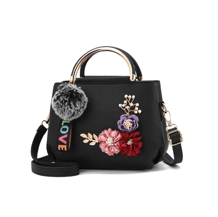 Elegant leather tote bag with delicate flower embellishments, perfect for modern British fashion