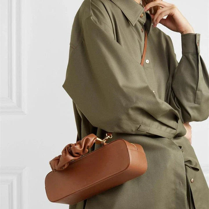 Sophisticated long shoulder diagonal bag with a sleek horizontal square design, made of durable synthetic leather and featuring a single shoulder strap for hands-free convenience.