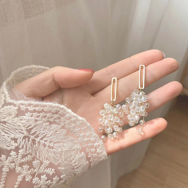 Elegant crystal grape cluster earrings with a cascading, geometric design in a premium gold finish