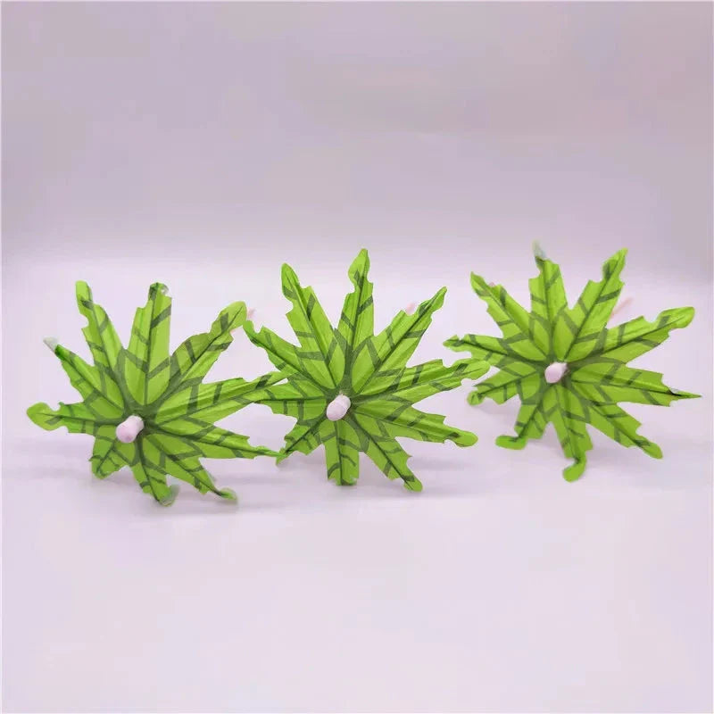 Mini coconut tree paper umbrellas in green, perfect for decorating cocktails, mocktails, and desserts at tropical-themed parties and events