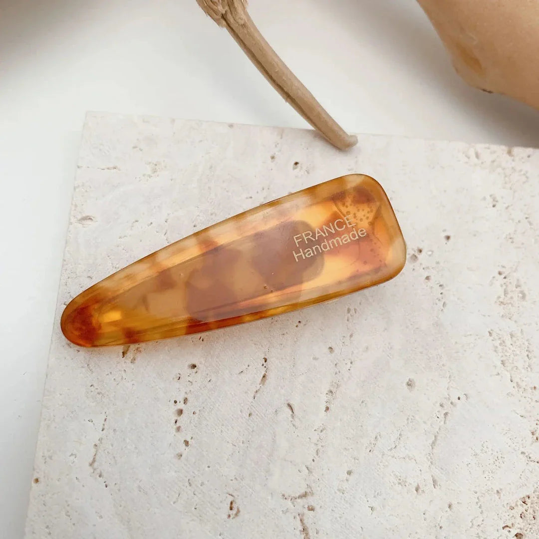 Two marble-patterned hair clips in a contemporary geometric design, made from high-quality acetate and acrylic materials.