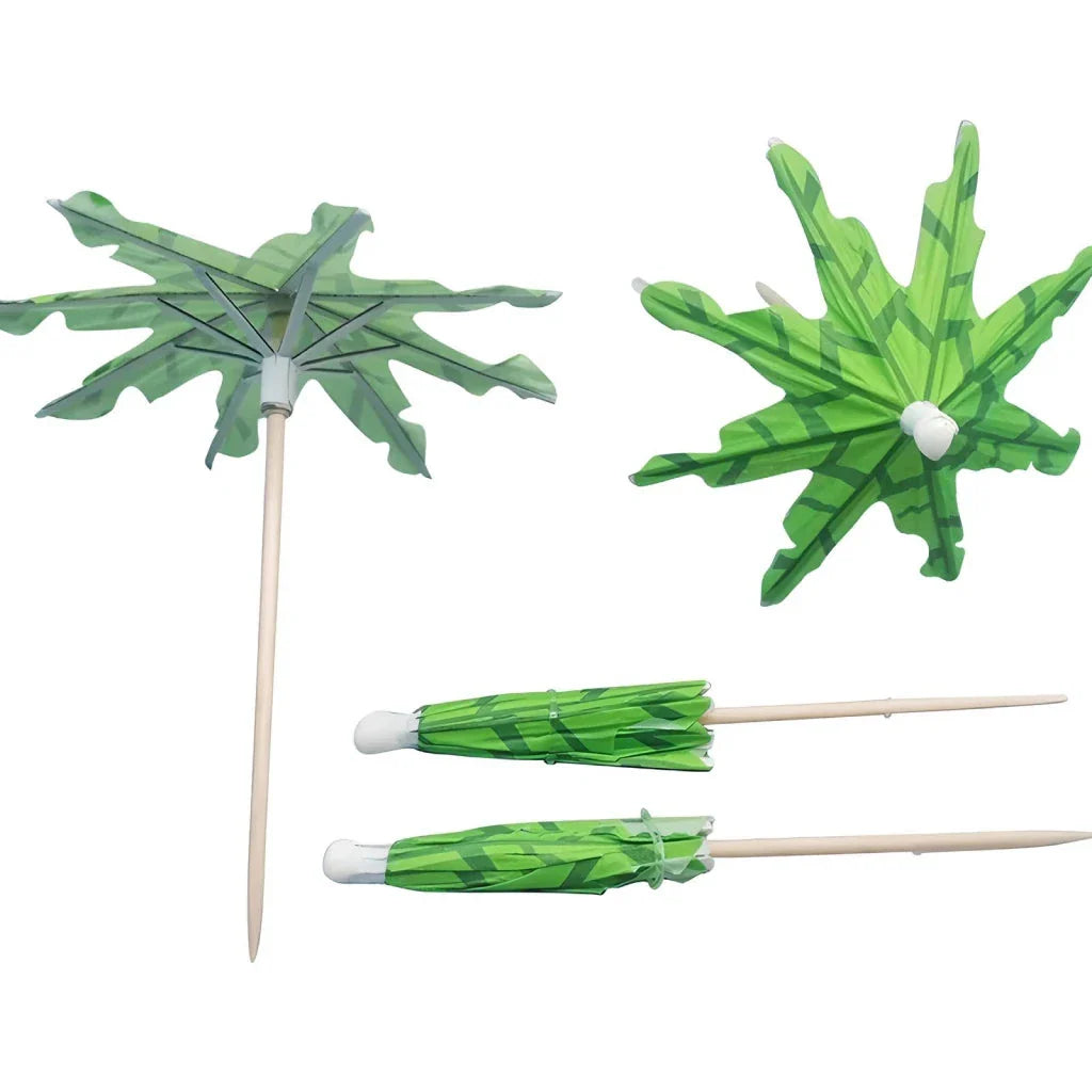 Mini coconut tree paper umbrellas in green, perfect for decorating cocktails, mocktails, and desserts at tropical-themed parties and events
