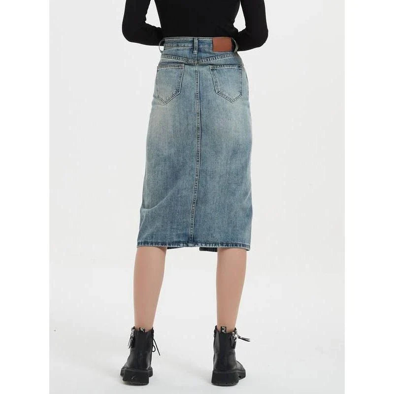A high-waist denim pencil skirt with a classic A-line silhouette, perfect for the modern British woman.