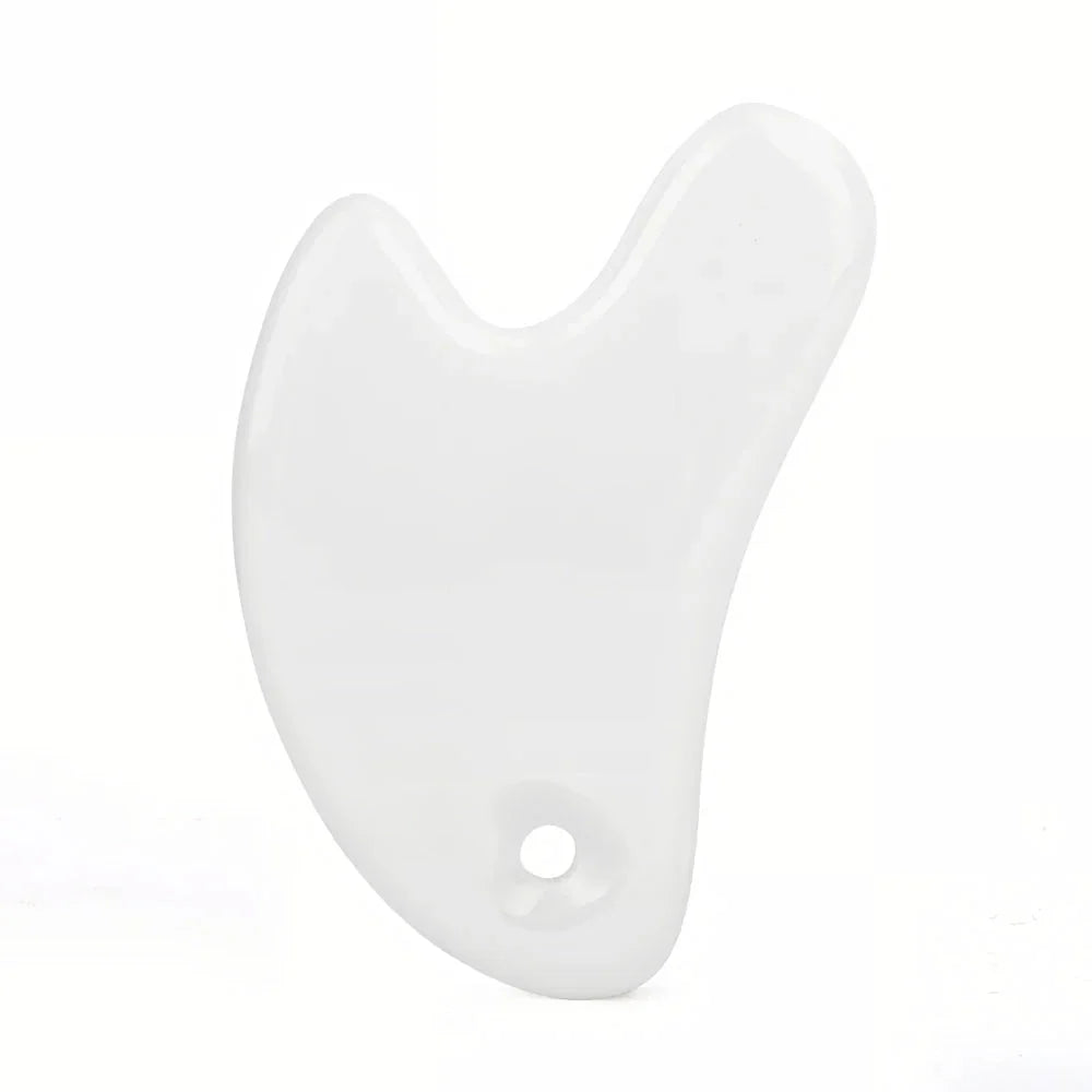 Ceramic Gua Sha facial massager in blue, pink, and white colours, designed to improve circulation and promote lymphatic drainage for radiant, youthful skin.