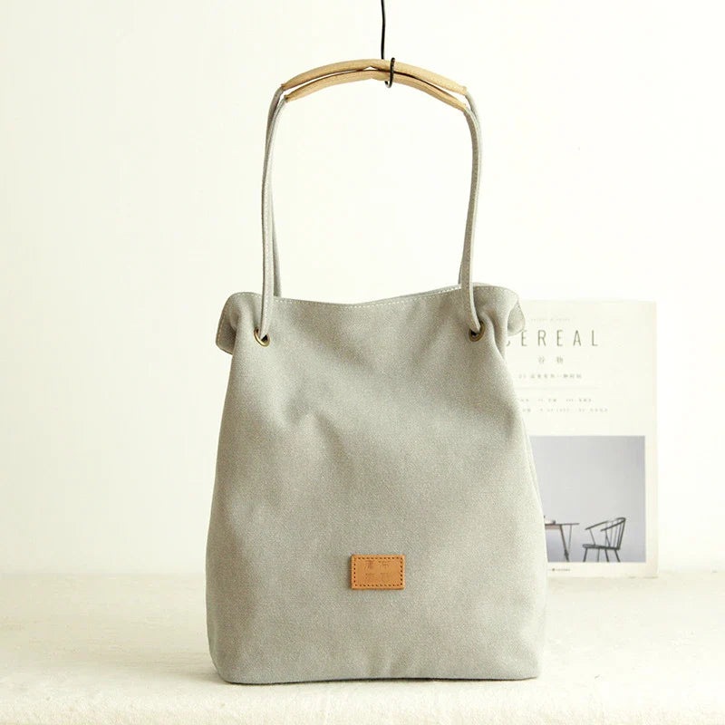 Premium canvas lattice shoulder bag in various colours, featuring a spacious design with secure zipper closure and adjustable strap for comfortable everyday carry