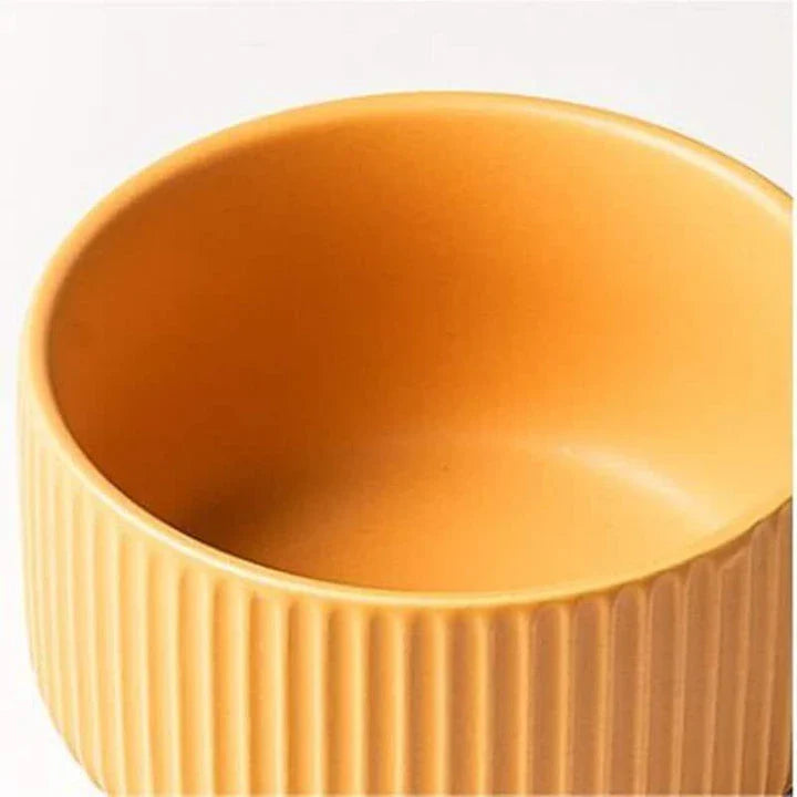 Candy-coloured ribbed ceramic tableware featuring plates, bowls, and other dining accessories in vibrant hues