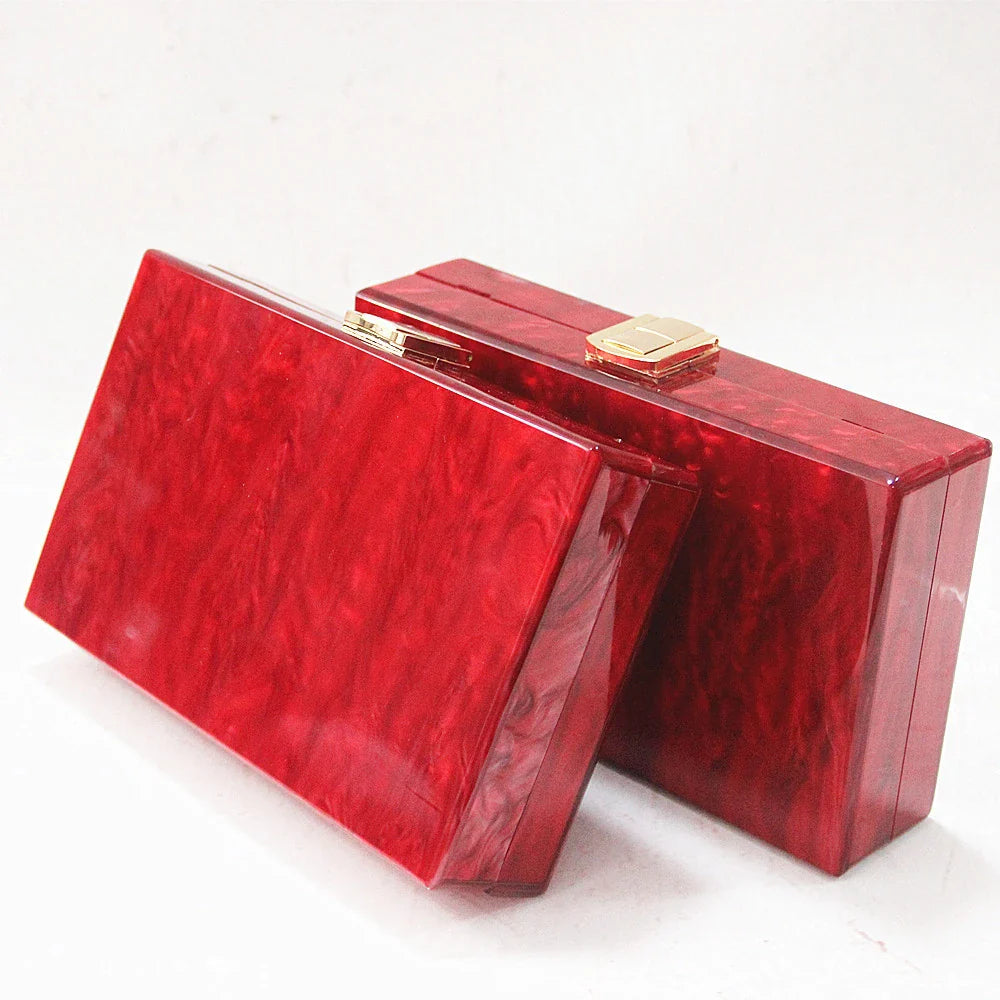 Stylish pearlescent acrylic clutch bag in red colour with a structured, square-shaped design